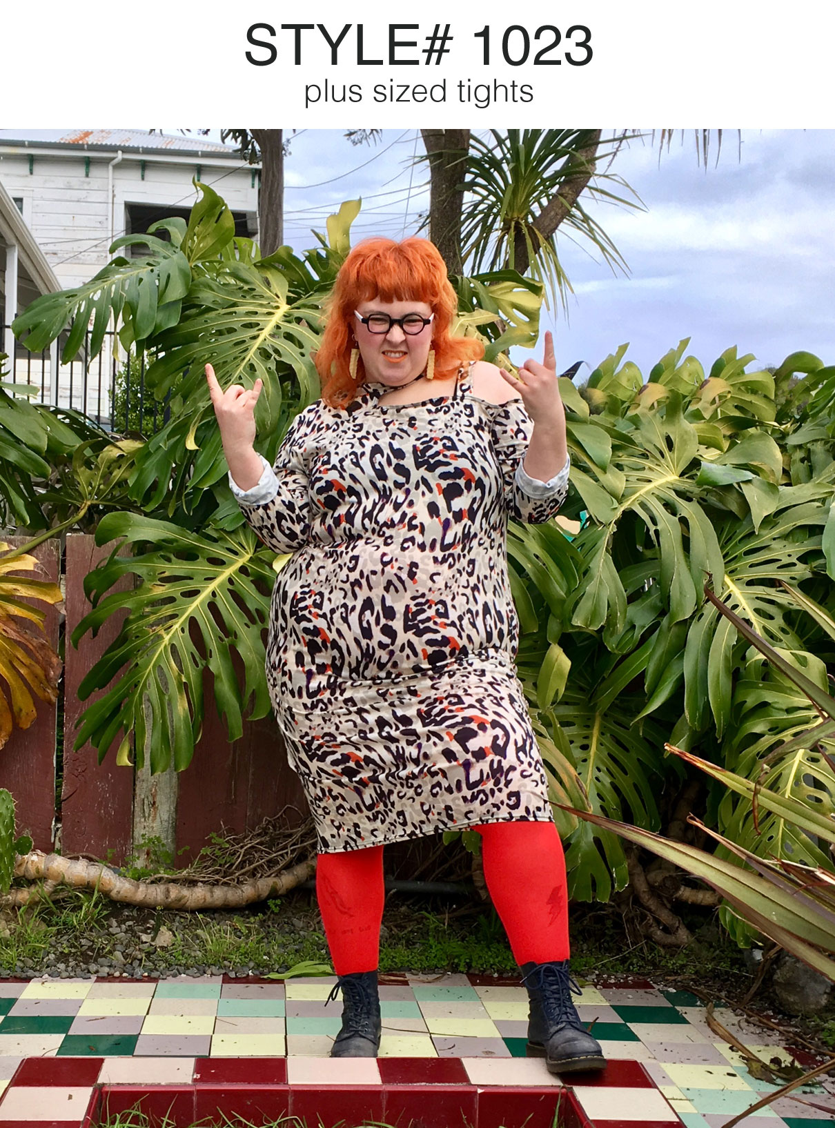 happy fierce plus size redhead woman wearing glasses leopard print dress red tights lace up boots 