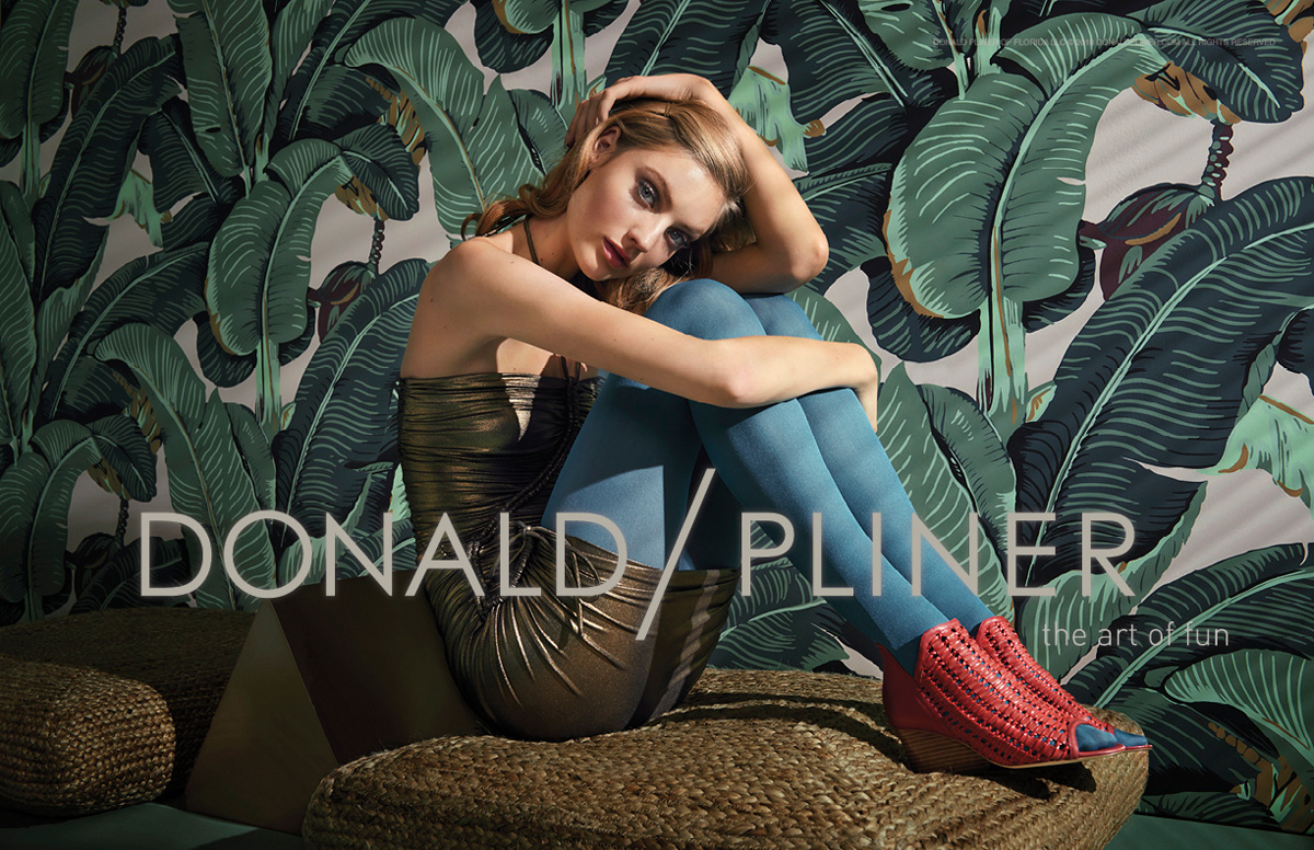 model sitting on a sofa with a plants background wearing colored tights and Donald Pliner Shoes