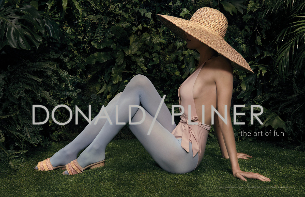 model sitting on the grass wearing colored tights and Donald Pliner Shoes