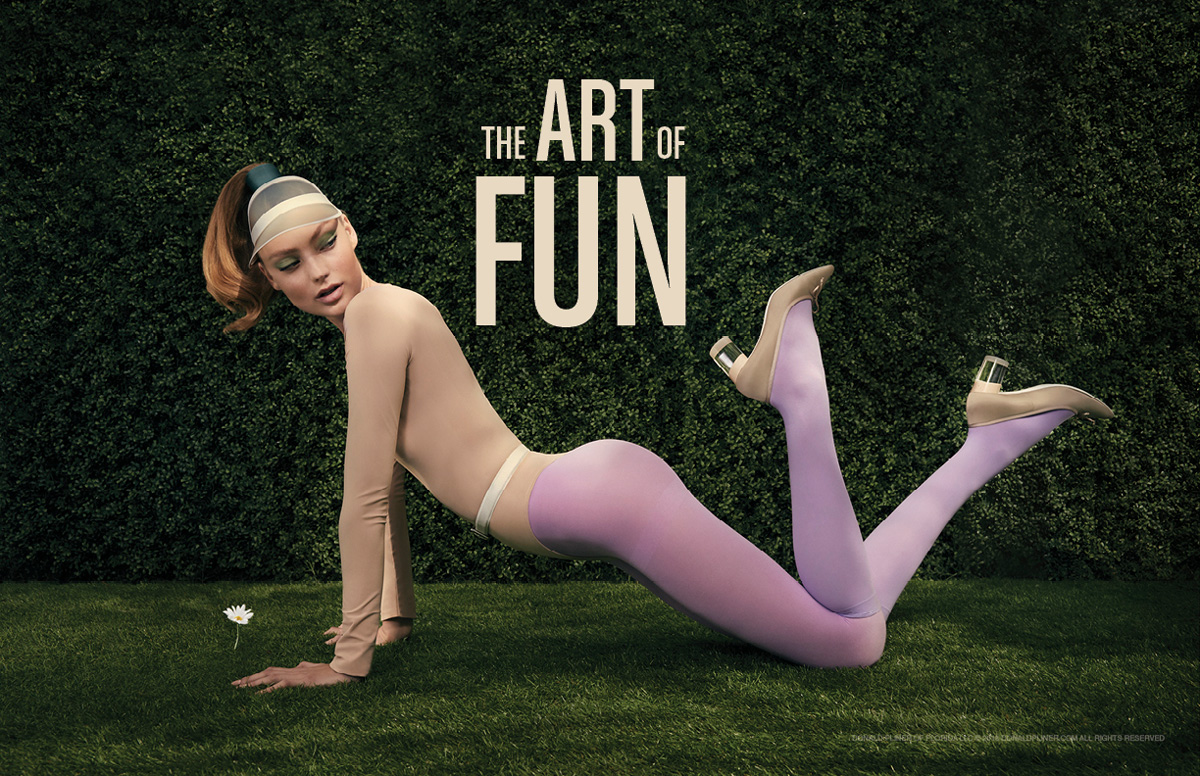 model laying down on the grass wearing colored tights and Donald Pliner Shoes