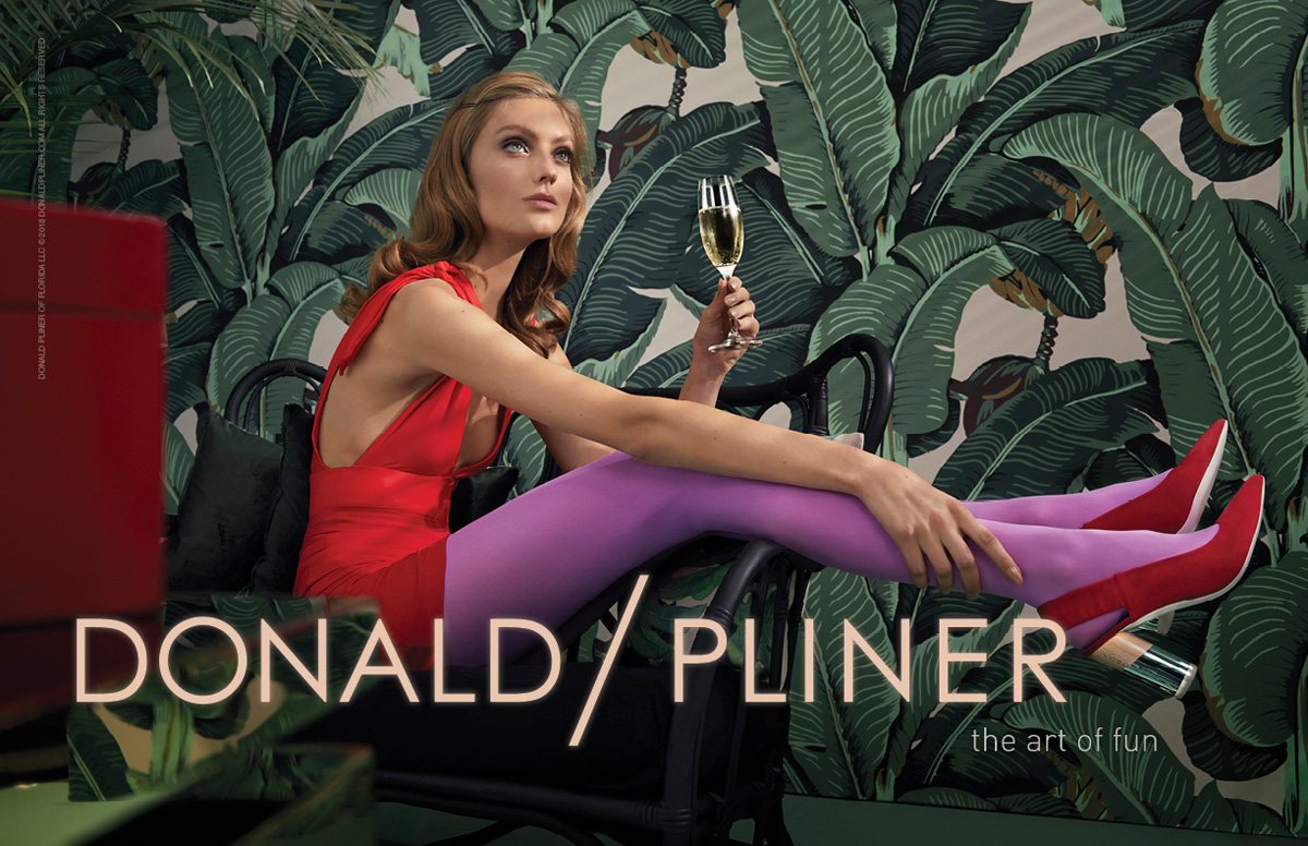 model laying down with a plants background wearing colored tights and Donald Pliner Shoes