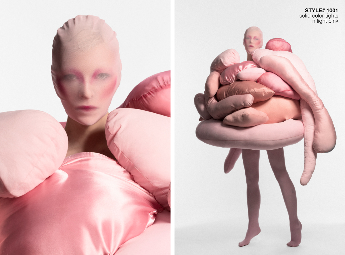 model wearing pink sculptured surreal garment in a white background